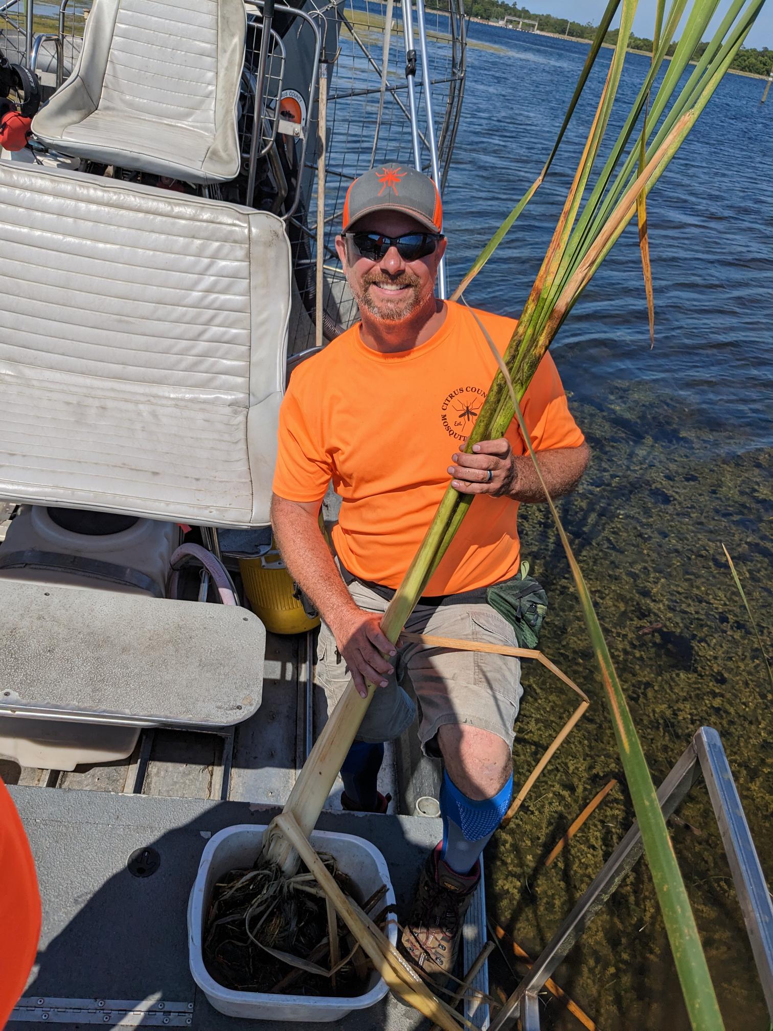 man holding plant on boat