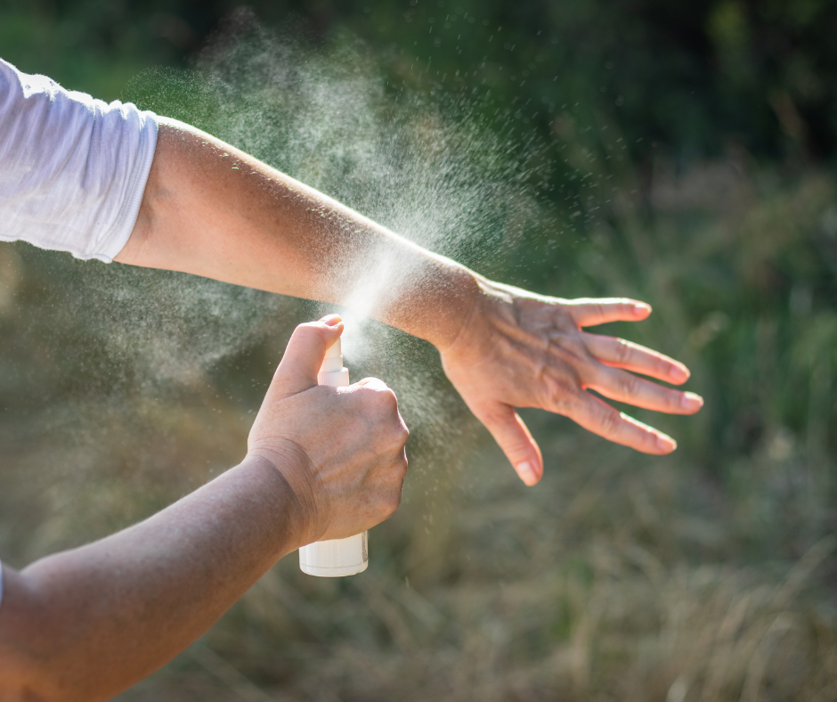 person spraying bug spray