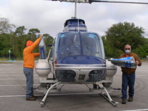 Employees loading helicopter